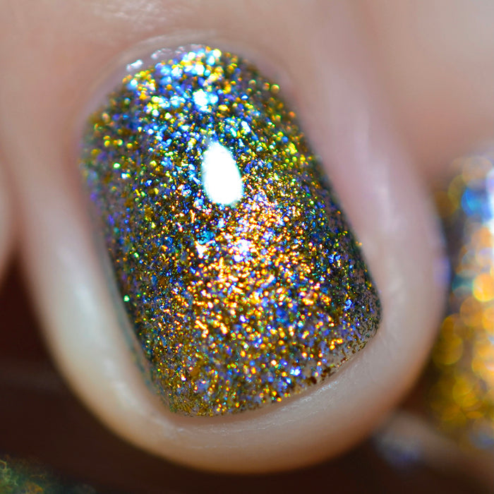 Close-up of one nail painted with Galerina Nail Lacquer on fair skin tone. Emphasizes flakey glitter.