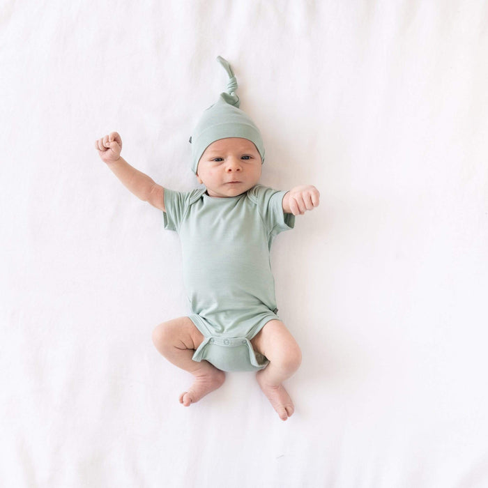 Newborn wearing  Knotted Cap in Sage and matching short sleeve bodysuit