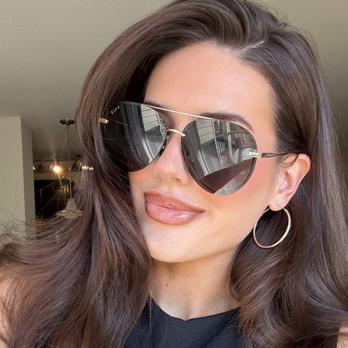 lifestyle - abigail herring wearing lenox gold g15 sunglasses with gold hoop earrings
