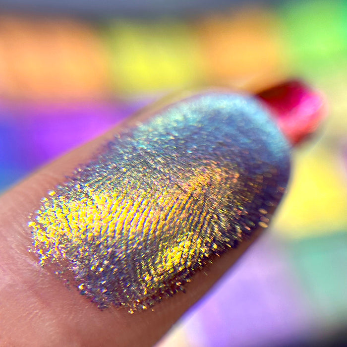 Macro finger swatch of Line of Queens Glitter Vibrant Multichrome Eyeshadow.