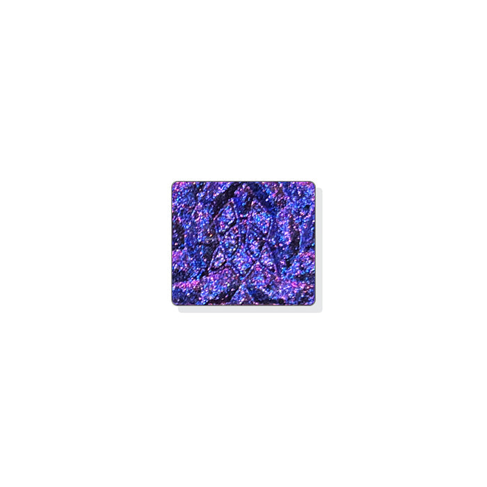 A single multichrome eyeshadow in colour Liquidus on a white background. A black base with medium sized particles that shift ultraviolet-pink-orange-grungy yellow with hints of red and cobalt sparkle.