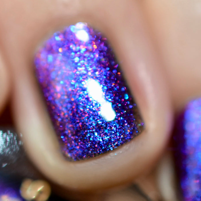 Close-up of one nail painted with Liquidus Nail Lacquer on fair skin tone.