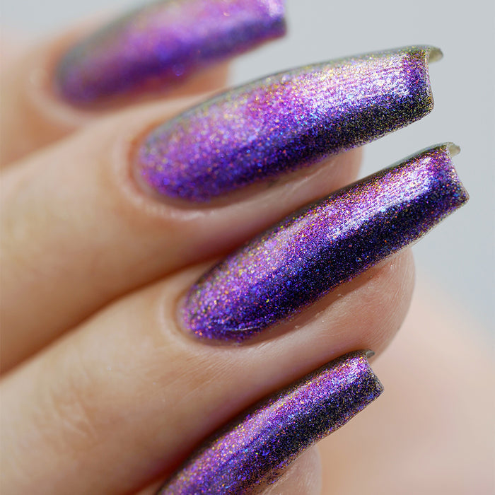 Close-up of nails painted with Liquidus Nail Lacquer on fair skin tone, on a blurred background.