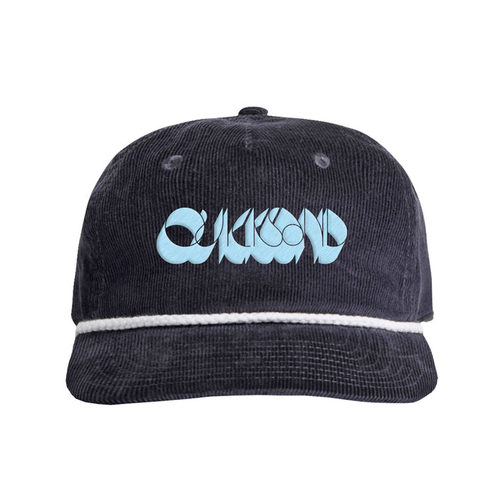 The Quicksand Black Corduroy Hat features a white rope detail above the brim and light blue stylized logo text on the front—a standout Logo Cap for any casual look.