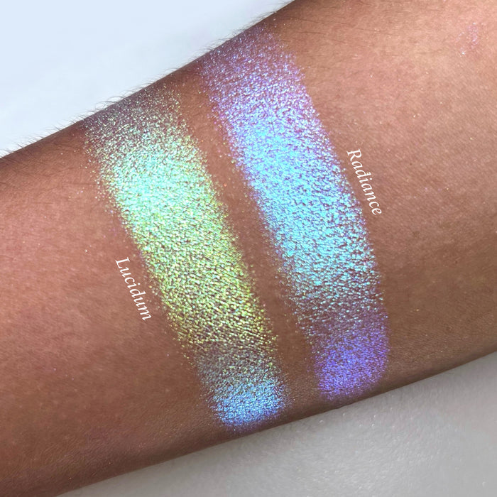 Top angled arm swatches on medium skin tone of Lucidum Series 2 Iridescent Mulitchrome eyeshadow shifts compared to Radiance