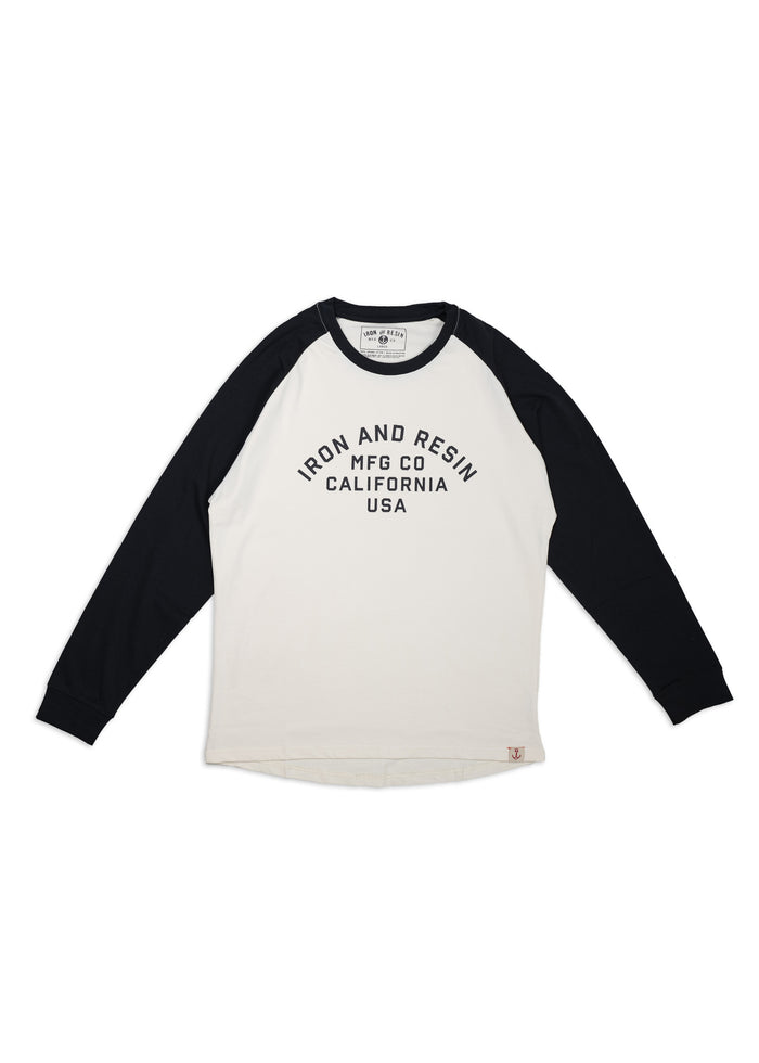 White and black raglan shirt with "Iron and Resin MFG Co California USA" text. Long sleeves, casual style, laid flat.