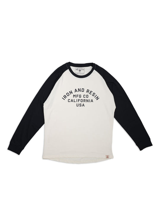 White and black raglan shirt with "Iron and Resin MFG Co California USA" text. Long sleeves, casual style, laid flat.
