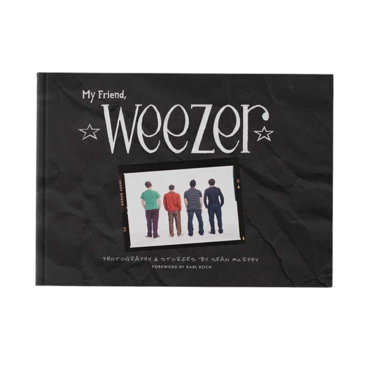 Black hardcover book my friend weezer with white stylized text and photo of rock bands in music photography from weezer official store