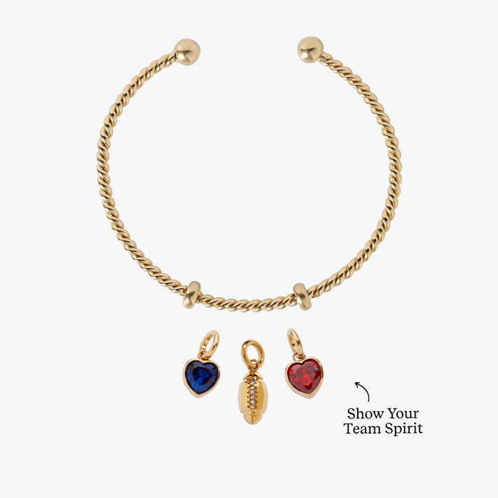 White bracelet with gold and red heart-shaped charms on a white background