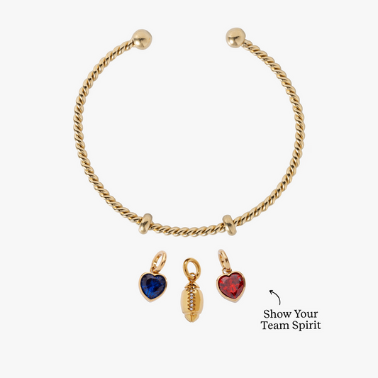 White bracelet with gold and red heart-shaped charms on a white background