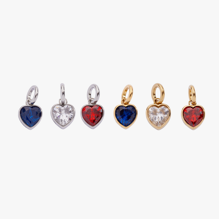 Set of heart-shaped jewelry charms in various colors on a white background