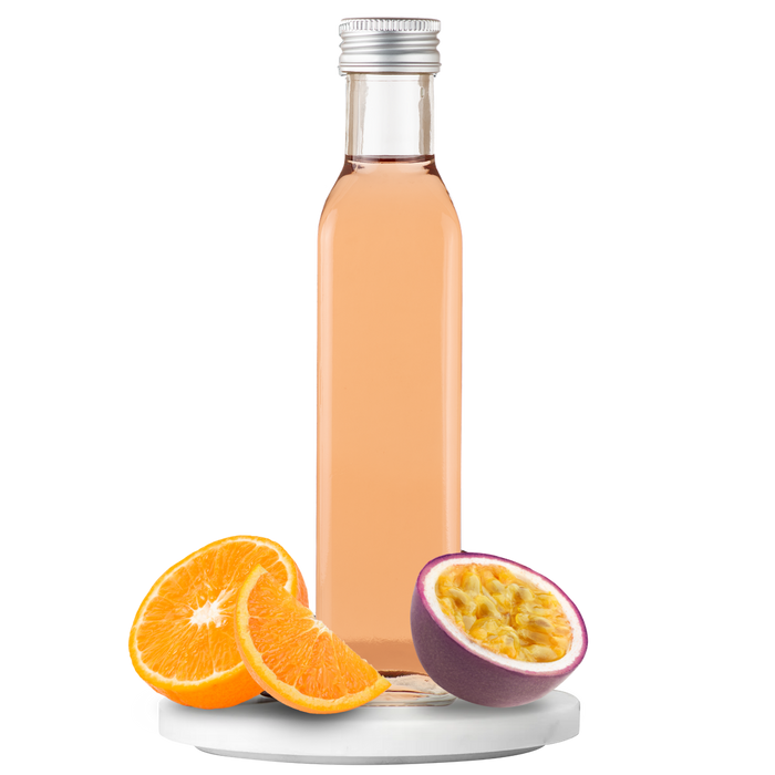 Bottle of vinegar with orange slices and a halved passion fruit