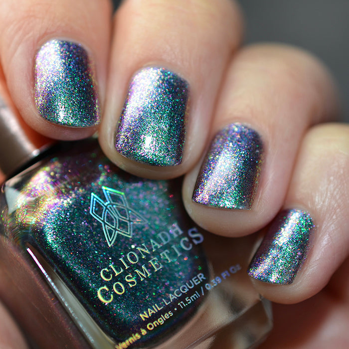 Close up shot of nails done with Oxidize nail lacquer on light skin tone holding a nail polish bottle