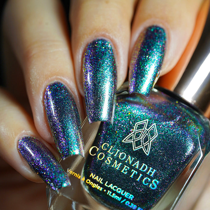 Close up shot of nails done with Oxidize nail lacquer on fair skin tone holding the nail lacquer bottle