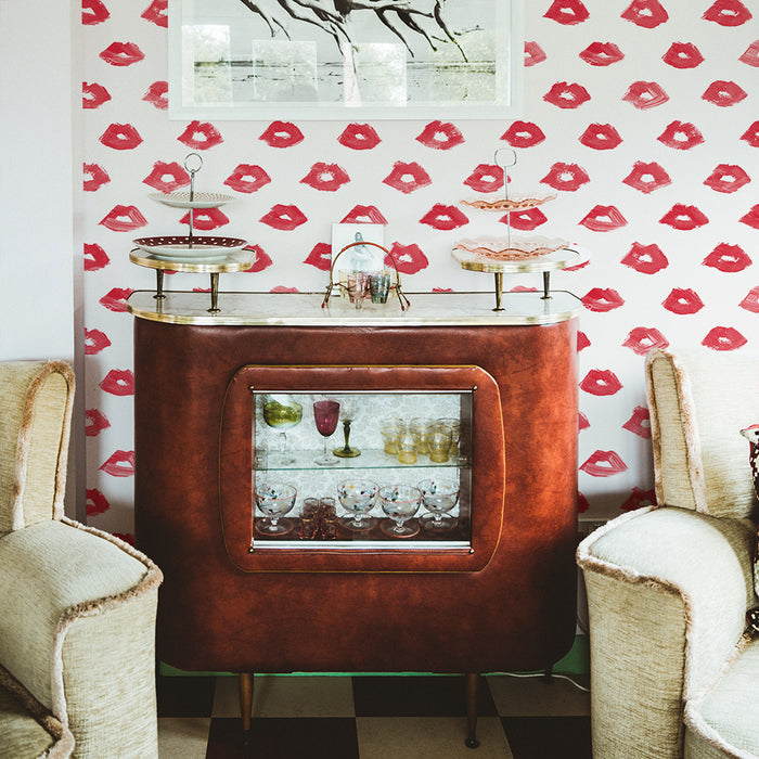 Painted Lips Removable Wallpaper - A wood barcart and two tan chairs in a room featuring Painted Lips Peel And Stick Wallpaper by Novogratz | Tempaper