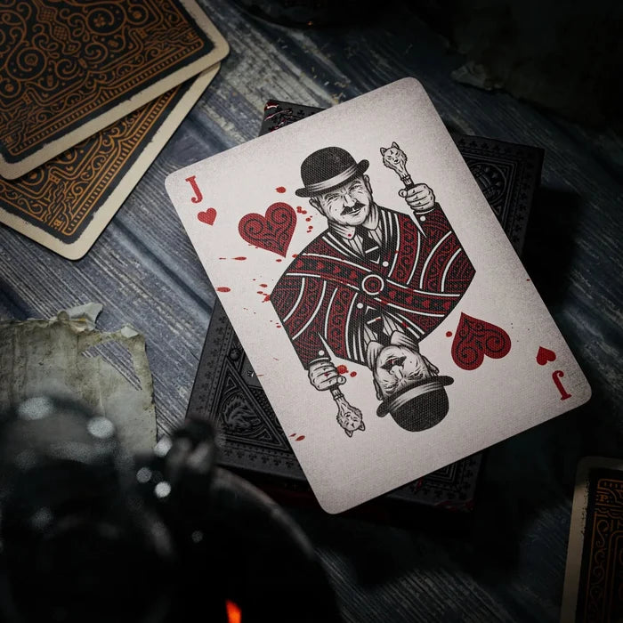 Playing card with a design of a man holding a heart and a sword on a wooden surface.