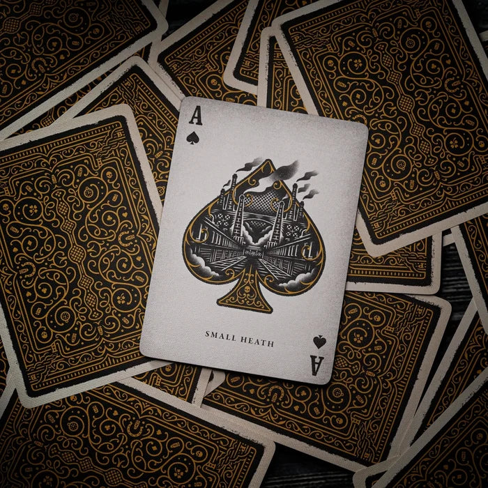 Peaky Blinders Playing card with ace of spades design on a dark wooden surface
