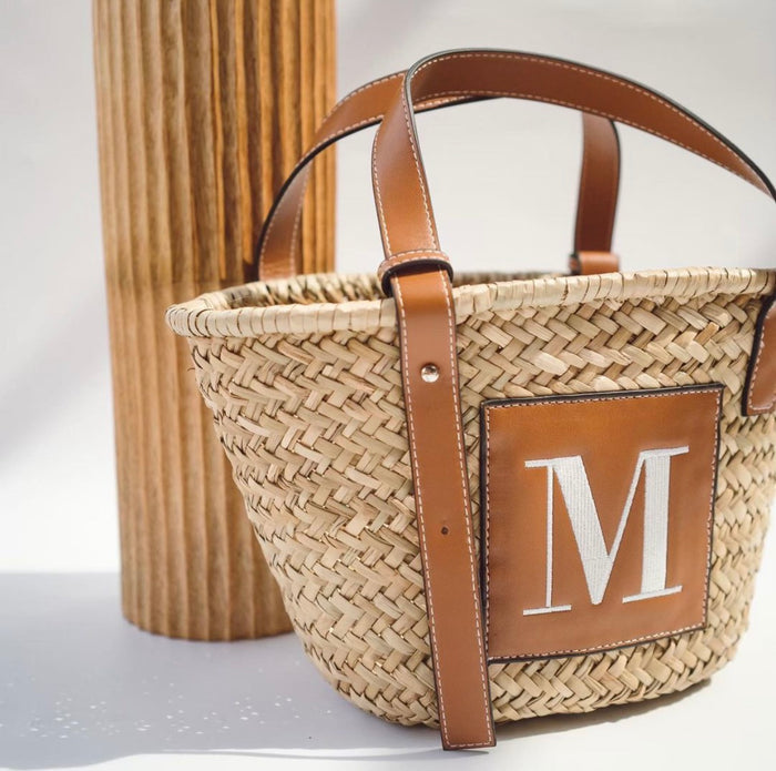 Seagrass basket handbag tote with brown leather straps and monogram M patch by Travellers Hat Boutique