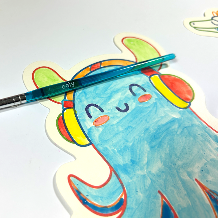Close up of painted octopus and paintbrush from the OOLY Ocean Fun Playful Painters Easy Watercolor Painting Kit on a white background