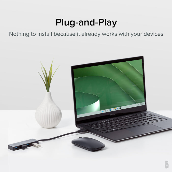 Plugable USB3-HUB4A 4-port USB 3.0 hub connected to a laptop, demonstrating plug-and-play functionality.