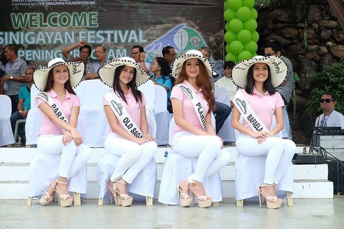 Women wearing custom floppy hat with pompoms by Travellers Hat Boutique at festival event
