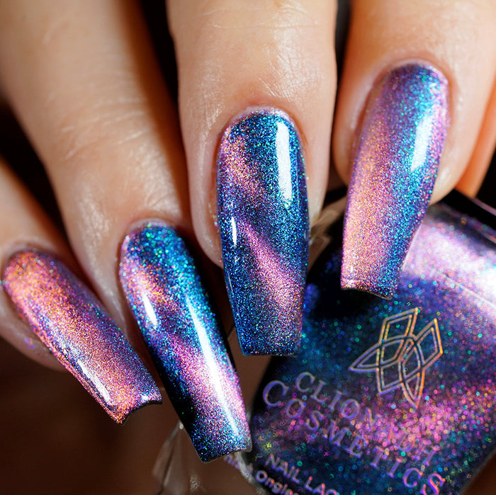 Close-up of nails painted with Psilocin Nail Lacquer on fair skin tone. Hand is holding polish bottle.