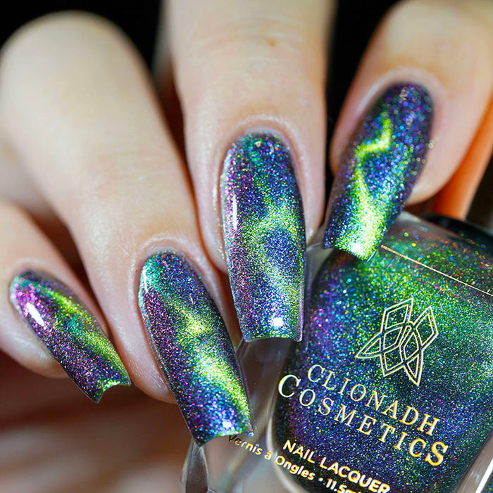 Close up of nails done with Psychonaut Nail Lacquer featuring a design to show off the magnetic effect on fair skin tone