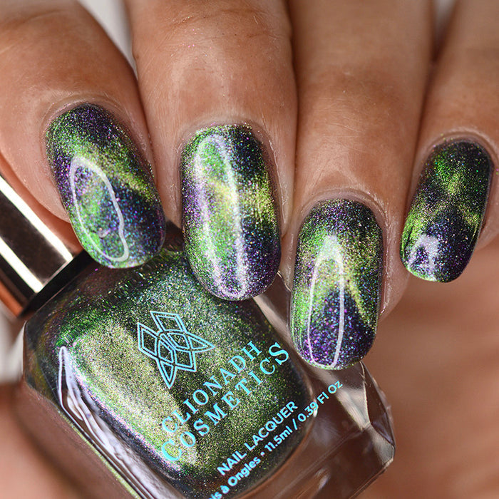 Close up of nails done with Psychonaut Nail Lacquer featuring a design to show off the magnetic effect on medium skin tone.