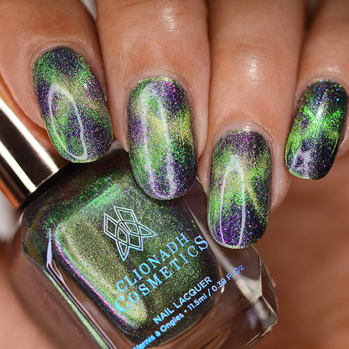 Close up of nails done with Psychonaut Nail Lacquer featuring a design to show off the magnetic effect on medium skin tone