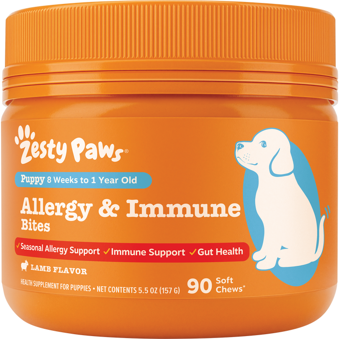 Orange jar of Zesty Paws puppy allergy and immune bites with blue illustration of a dog and orange ribbed cap.