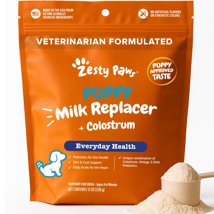 Orange pouch of Zesty Paws puppy milk replacer powder with colostrum, 12 oz, displayed with a scoop of powder.