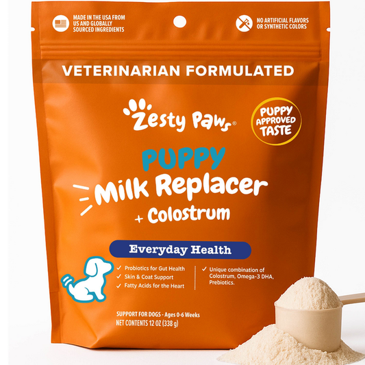 Orange pouch of Zesty Paws puppy milk replacer powder with colostrum, 12 oz, displayed with a scoop of powder.