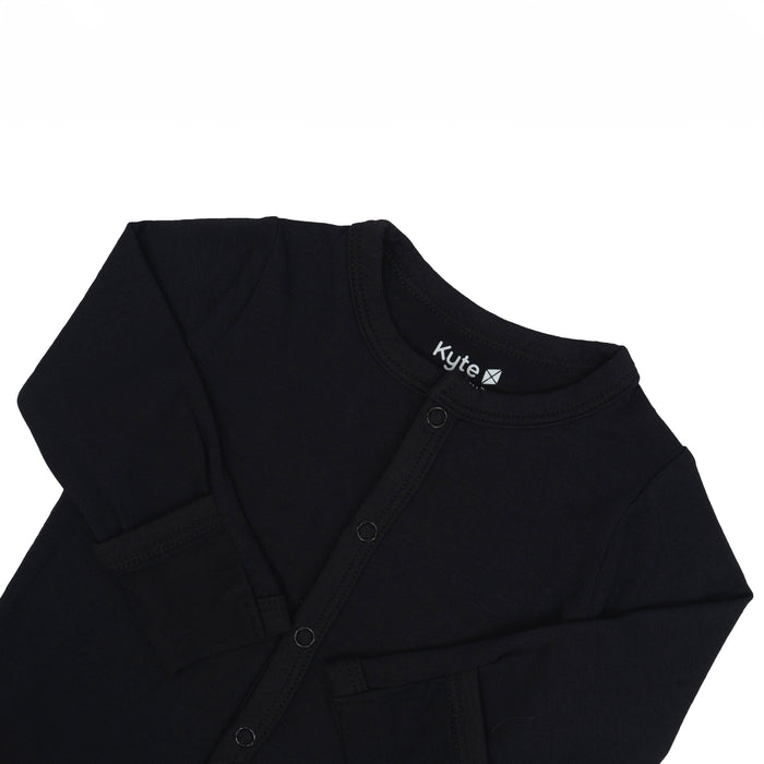Fold-over cuffs on Kyte Baby Romper in Midnight with arms folded in