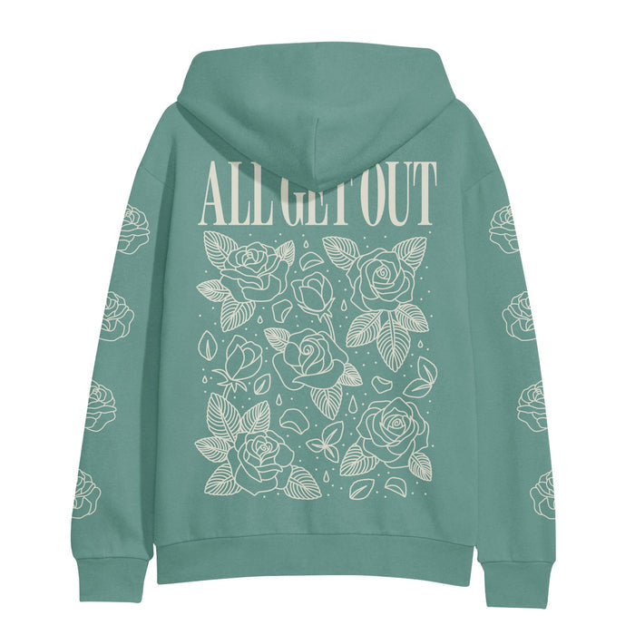 We see the backside of a soft green mint colored hoodie with text on top that reads, ALL GET OUT. Below the text is an elegant display of roses that are shown as a white outline against the mint green hoodie color.