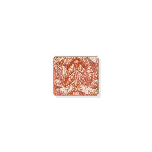 A single multichrome eyeshadow in colour Scroll on a white background. A creamy orange base with a bright, pearly pink-silver-aqua shift.