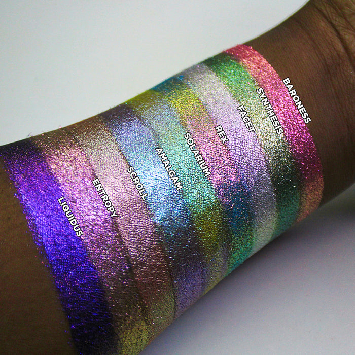 Arm swatches of the Halloween Stained Glass Expansion Bundle shadows on deep skin tone.