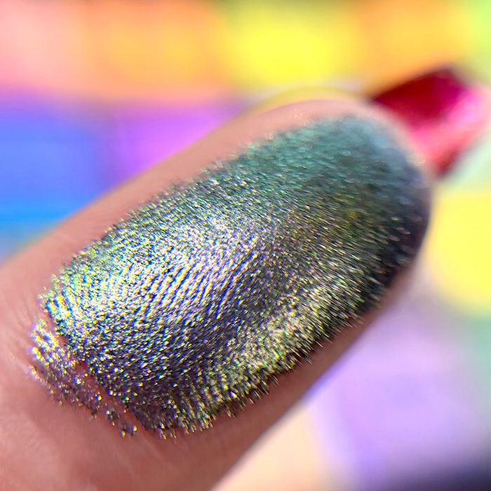 Macro finger swatch of Sculpture Earth Vibrant Multichrome Eyeshadow.