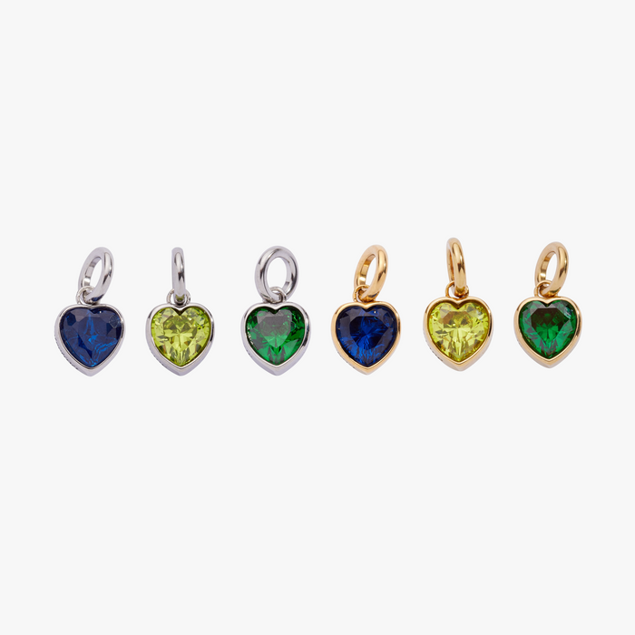 Set of heart-shaped gemstone pendants in various colors on a white background