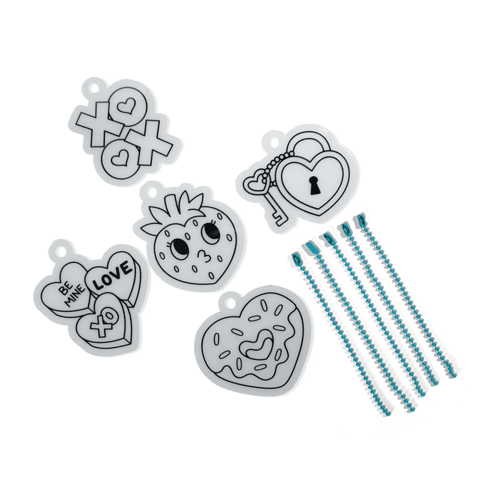 Contents of OOLY Mini Shrink-Its! DIY Shrink Art Kit - Hugs & Kisses with uncolored charms and beads