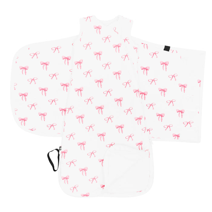 Kyte Baby's Sleep Bag Swaddler in Bow 1.0 shown unswaddled with the bottom zipper undone