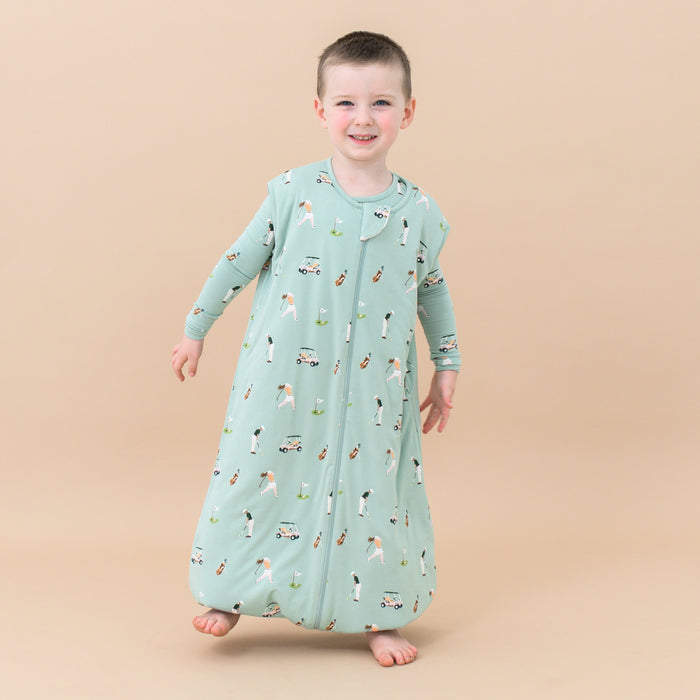 Toddler standing on one leg wearing Sleep Bag Walker in Golf 1.0