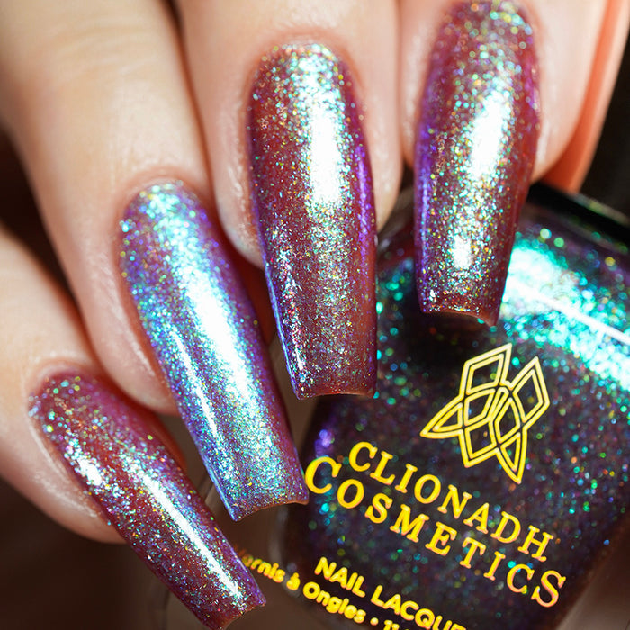 Close-up of nails painted with Smedge Haze Nail Lacquer on fair skin tone. Hand is holding polish bottle.