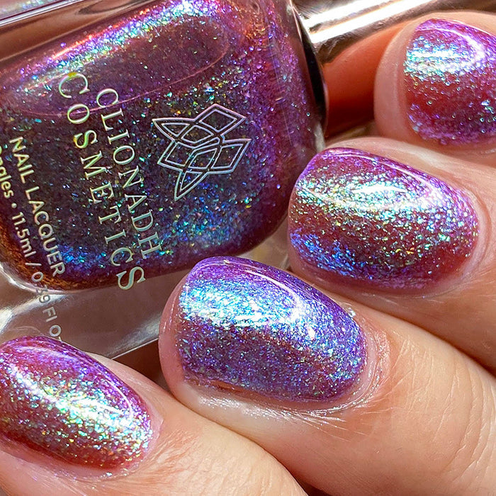 Close-up of nails painted with Smedge Haze Nail Lacquer on fair skin tone. Hand is holding polish bottle.