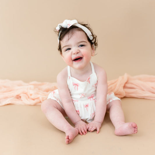 Young toddler wearing Spaghetti Strap Ruffle Romper in Bow