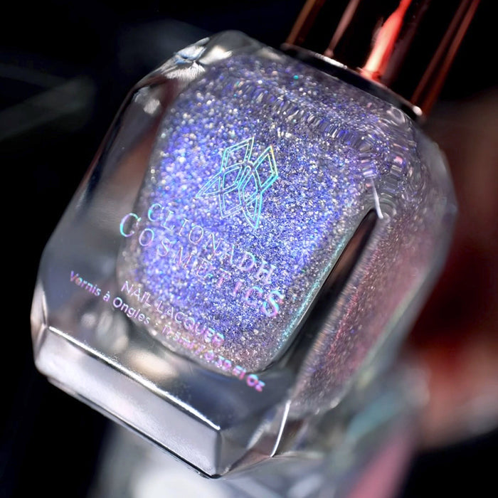 Angled, close-up of Spilled Salt Nail Lacquer bottle, on a blurred background.