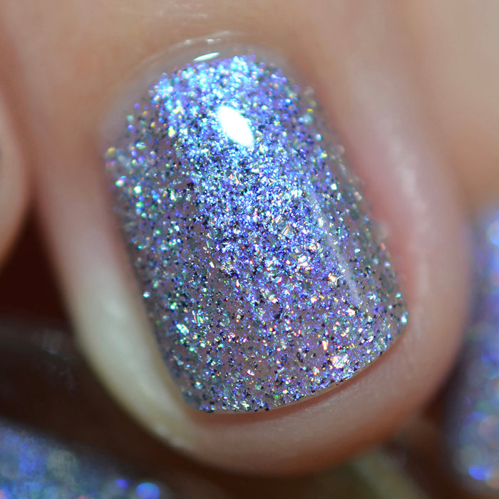 Close-up of one nail painted with Spilled Salt Nail Lacquer on fair skin tone.