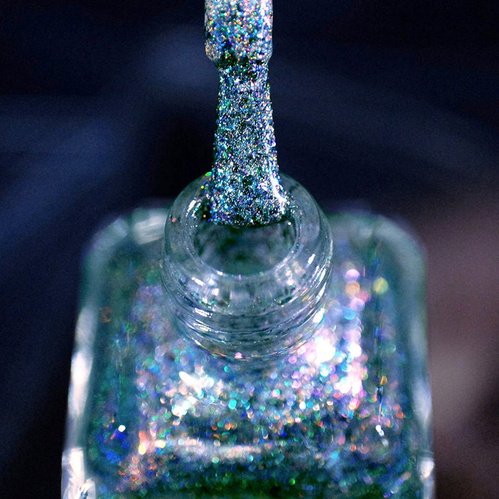 Close-up of nail polish bottle and brush showing product Step on a Crack Nail Lacquer, on a blurred background.