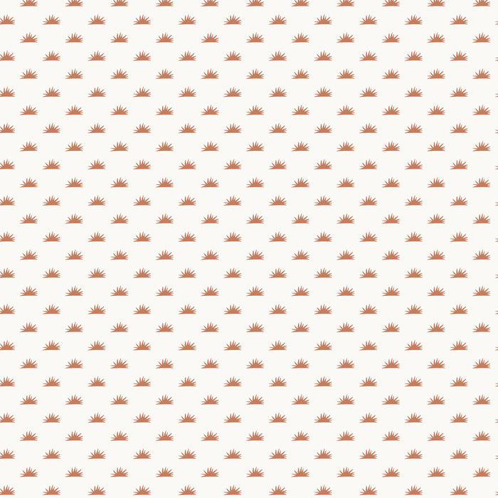 Small copper burst of sunshine repeating on Tempaper's copper haze Sunbeam removable wallpaper.