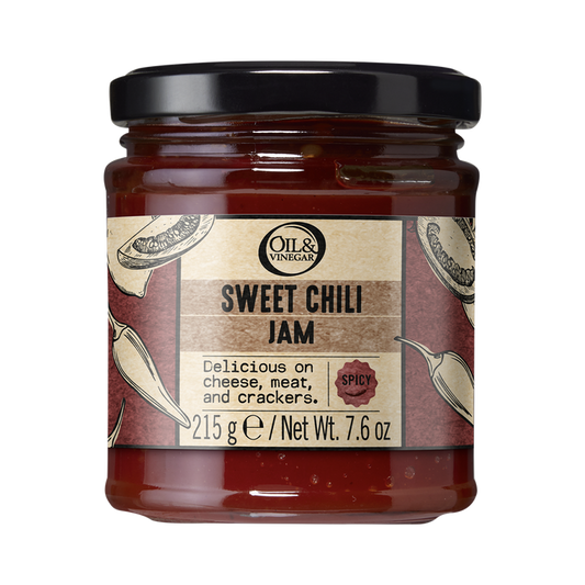A jar of sweet chili jam with a label that includes images of chili peppers indicating the flavor profile of the product.