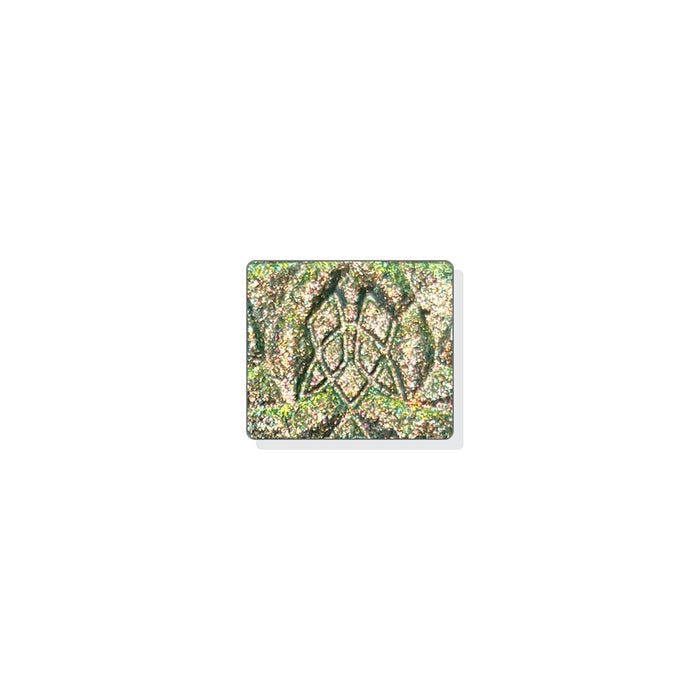 A single multichrome eyeshadow in colour Synthesis on a white background. A green-grey base and particles that shift copper-yellow-green with hints of silver and aqua sparkle.